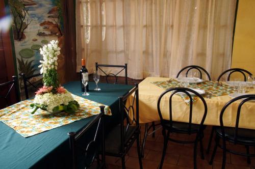 two dining tables with chairs and flowers on them at Boutique Hotel Casa Orquídeas in San José
