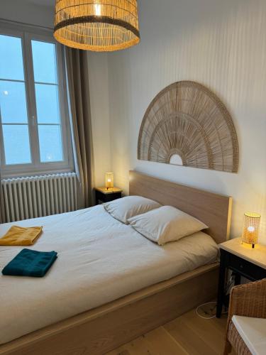 a bedroom with a bed and a large mirror at Le Charmant in Tours
