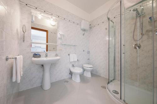 a bathroom with a sink and a toilet and a shower at Villa San Lorenzo in Scala