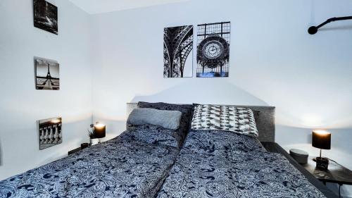 a bedroom with a bed and some pictures on the wall at Apartmenthaus - Am Bergstollen in Dielmissen