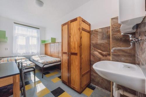 a bathroom with a sink and a toilet and a tub at Rekreační středisko ROJANA in Svratka