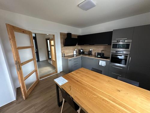 a kitchen with a wooden table in a room at Vila Kosmonautka - Velké Losiny in Velké Losiny