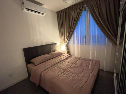 a bedroom with a bed with a large window at Hana Guesthouse Metrocity (Nearby City Centre) in Kuching