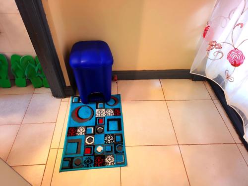 a floor with a blue trash can in a room at The Little Haven - Ample Parking, Views & Netflix in Kikuyu