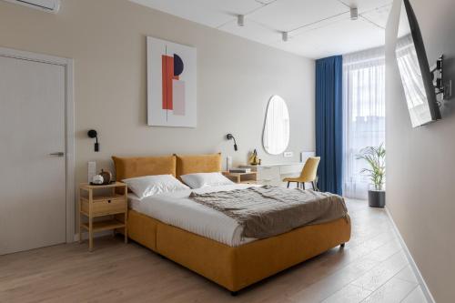 a bedroom with a bed and a desk in it at Old City Apartments in Lviv