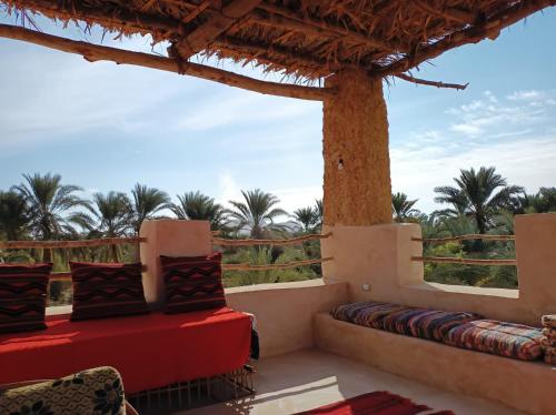a balcony with a view of palm trees at مراقي سيوة Maraqi Siwa in Siwa