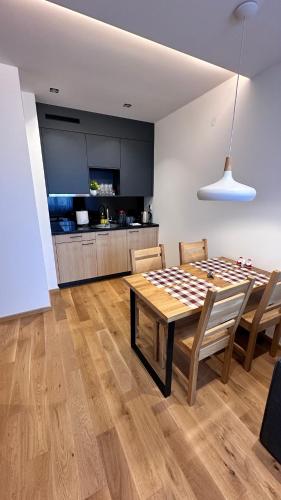 a dining room with a checkered table and chairs at Zlatni Javor 207 Jahorina in Jahorina