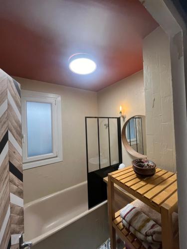 a bathroom with a sink and a mirror at La cabane in Fontaine