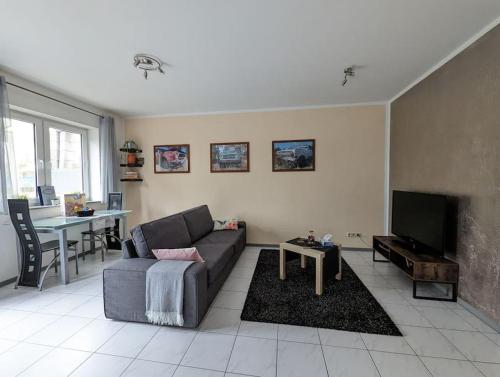 a living room with a couch and a tv at Welcome in Weilerbach in Weilerbach