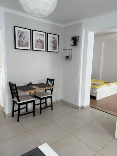 a dining room with a table and two chairs at Mondorf - klein aber fein zwischen Bonn & Köln in Niederkassel