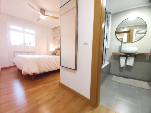 a bedroom with a bed and a mirror at Sleeping & Living Haro in Haro