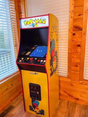 a colorful pizza man arcade game in a room at Luxurious Pigeon Forge Cabin, w/ HotTub, EasyDrive, Arcade Game, Panoramic Views in Pigeon Forge