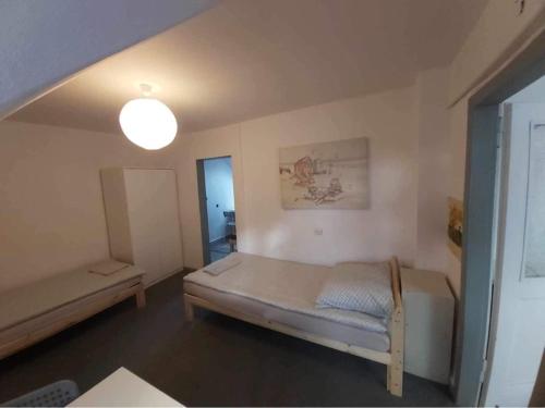 a bedroom with a large bed and a lamp at Seaside Holiday House in Gdańsk