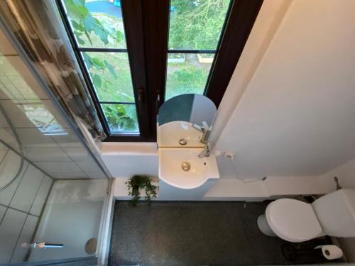 a bathroom with a toilet and a window at Seaside Holiday House in Gdańsk