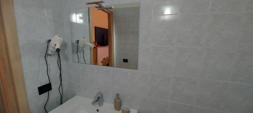 a bathroom with a white sink and a mirror at CASA JO in Bari