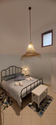 a bedroom with a bed and a table and a lamp at CASA JO in Bari