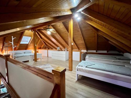 a attic room with a bed and a sink at Haus Palazzo in Bosanska Krupa