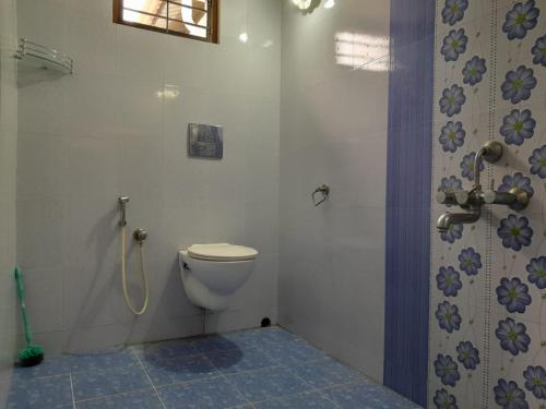 a bathroom with a toilet and a shower at Beena Homestay in Fort Kochi