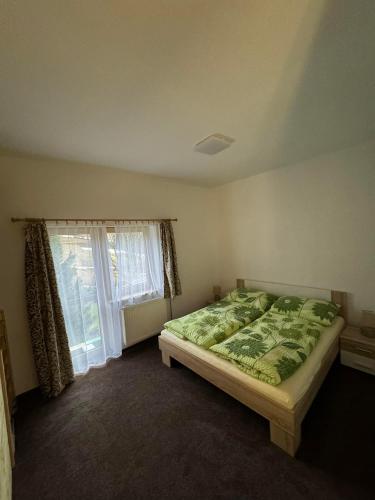 a bedroom with a bed and a window at U Edyho in Zuberec