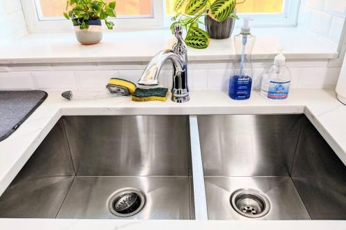 a stainless steel sink in a kitchen at ENTIRE Garden Apt-Private Parking+Central Location in Vancouver