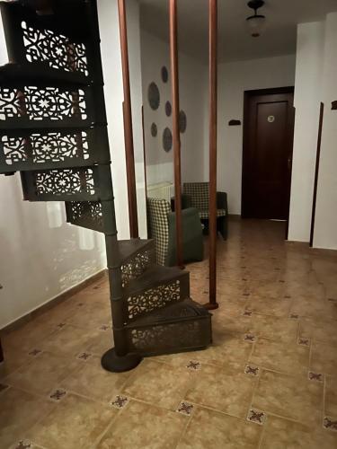 a room with a spiral staircase in a building at Hotel Restaurante Benidorm 1970 in Villamayor
