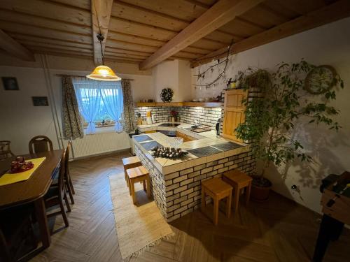 a kitchen with a stove and a table and chairs at U Edyho in Zuberec