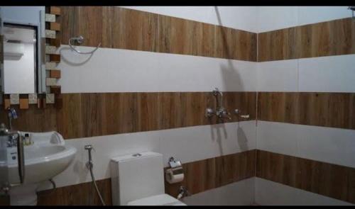 a bathroom with a toilet and a sink at The Buddha Resort in Gaya