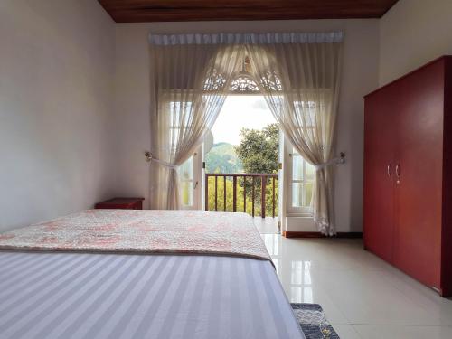 a bedroom with a bed and a large window at European B & B Hotel in Bandarawela