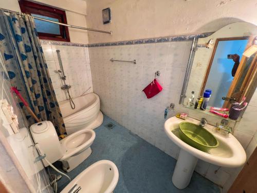 a bathroom with a sink and a toilet and a mirror at European B & B Hotel in Bandarawela
