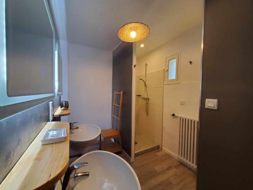 a bathroom with two sinks and a toilet and a shower at LA FONTAINE AU LOUP in Saint-Maurice-sur-Eygues
