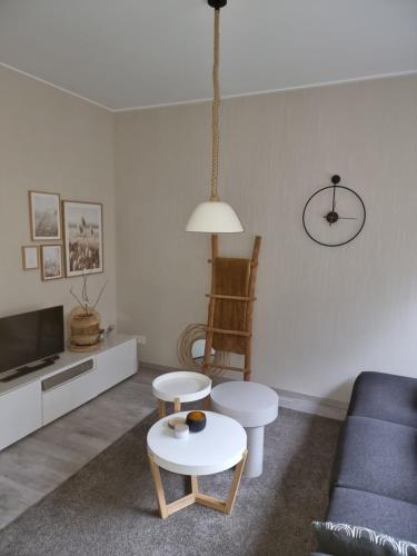 a living room with a couch and a table at Logeren bij Sabine en JW in Beekbergen