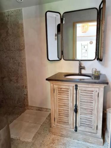 a bathroom with a sink and a mirror at Le Mas du Castellas 5* in Le Thor