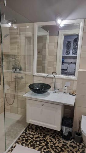 a bathroom with a sink and a glass shower at APARTAMENT w CENTRUM O&K in Augustów