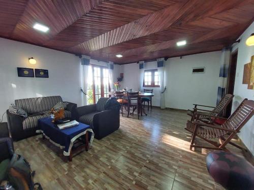 a living room with a couch and chairs and a table at B&B Nuwara eliya in Nuwara Eliya