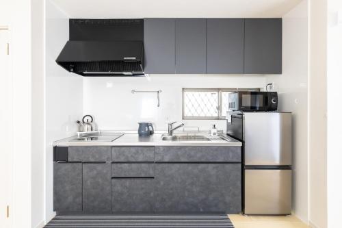 a kitchen with a sink and a refrigerator at HAN'S EBISU - Shibuya - Entire House for Max 10 ppl in Tokyo