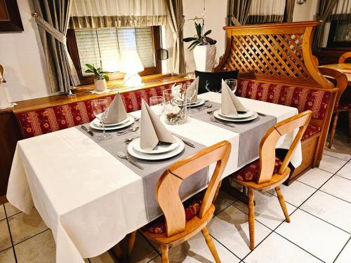 a table with a white table cloth and napkins on it at Landgasthaus Sternen in Kehl am Rhein