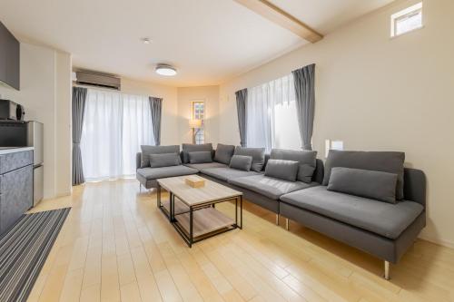 a living room with a couch and a table at HAN'S EBISU - Shibuya - Entire House for Max 10 ppl in Tokyo