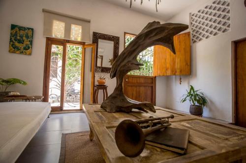 una sala de estar con una mesa con una estatua. en Casa Moraira, en Cartagena de Indias
