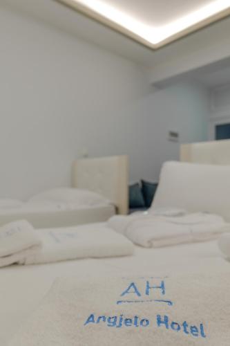 an airplane hotel sign on a bed in a room at Hotel Angjelo in Borsh