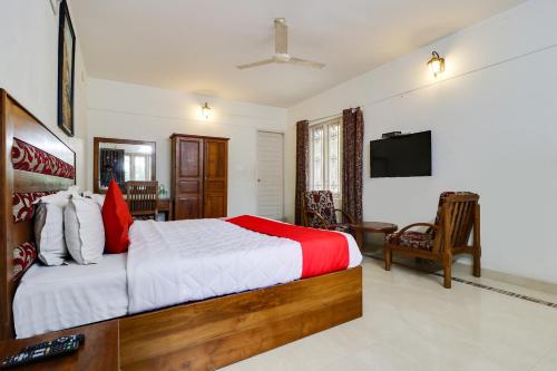 a bedroom with a bed and a television in it at Star Inn Hotel in Trivandrum