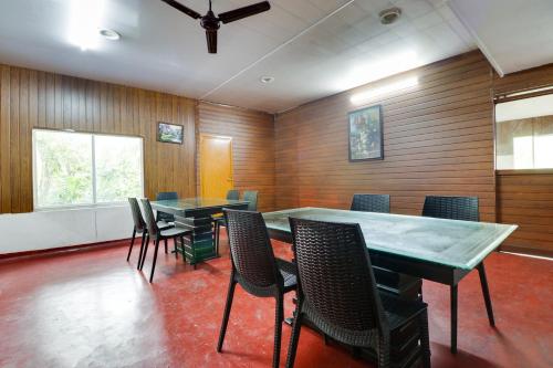 a conference room with wooden walls and tables and chairs at Star Inn Hotel in Trivandrum