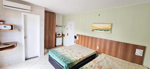 a small room with a small bed in a room at Thermas Place by Esteves em Caldas in Caldas Novas