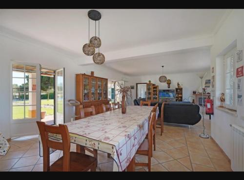 a dining table and chairs in a living room at O Cantinho dos Vieiras in Grândola