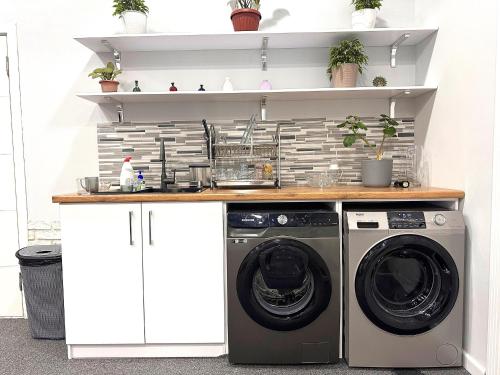 a laundry room with a washer and dryer at Stay Hostel in Bishkek
