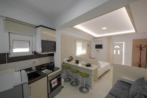 a small kitchen with a sink and a counter top at Hotel Angjelo in Borsh