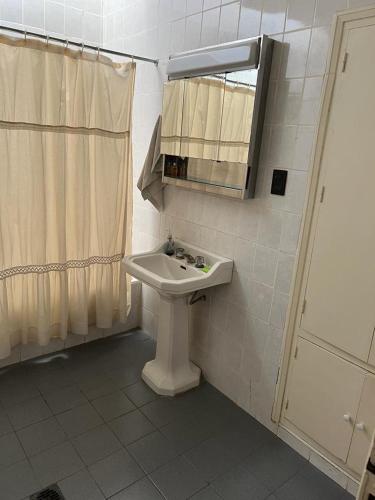 a bathroom with a sink and a mirror at Casa Rufino Ortega in Mendoza