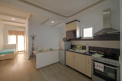 a kitchen with a sink and a stove top oven at Hotel Angjelo in Borsh