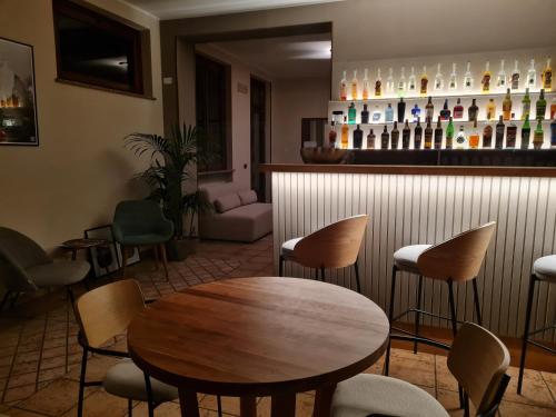 a restaurant with a table and chairs and a bar at Manfredi ristorante con alloggio in Romentino