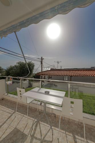 a white table and chairs on a balcony at Hotel Angjelo in Borsh