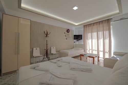 a hotel room with a bed with towels on it at Hotel Angjelo in Borsh